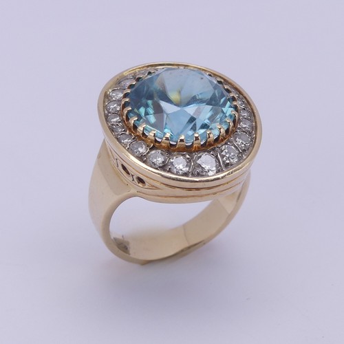 200 - A blue topaz and diamond Dress Ring, the circular facetted topaz approx. 12.3mm diameter, surrounded... 