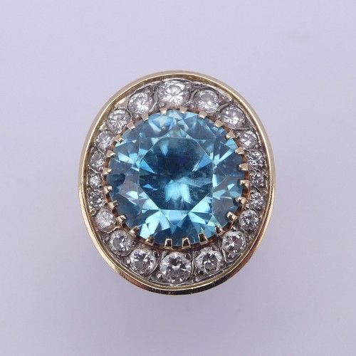 200 - A blue topaz and diamond Dress Ring, the circular facetted topaz approx. 12.3mm diameter, surrounded... 