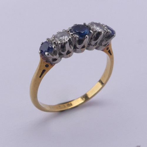 210 - A sapphire and diamond five stone Ring, the central sapphire approx. 4mm diameter, mounted in 18ct g... 