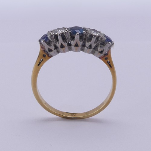 210 - A sapphire and diamond five stone Ring, the central sapphire approx. 4mm diameter, mounted in 18ct g... 