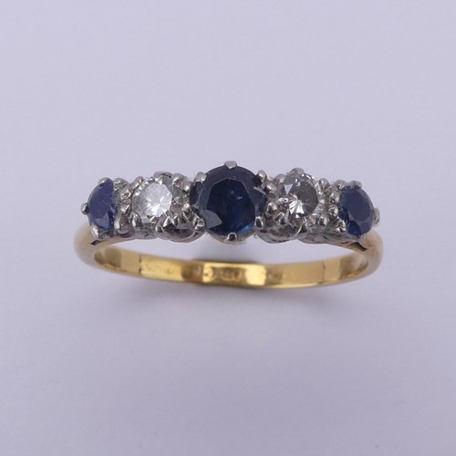 210 - A sapphire and diamond five stone Ring, the central sapphire approx. 4mm diameter, mounted in 18ct g... 