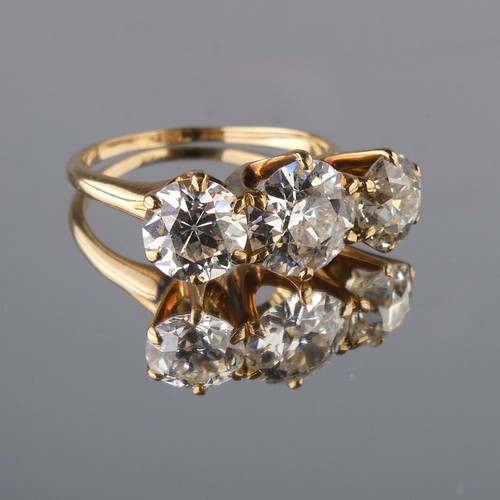 214 - A three stone diamond Ring, the central brilliant cut stone approx. 1.5ct with the outer stones each... 