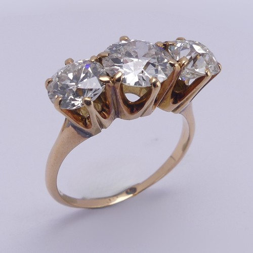 214 - A three stone diamond Ring, the central brilliant cut stone approx. 1.5ct with the outer stones each... 