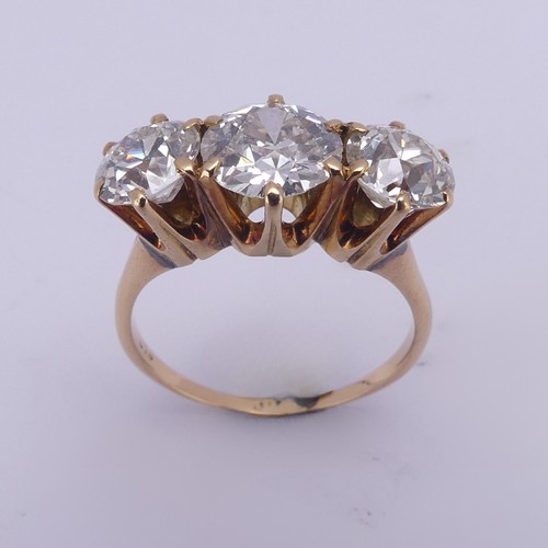 214 - A three stone diamond Ring, the central brilliant cut stone approx. 1.5ct with the outer stones each... 