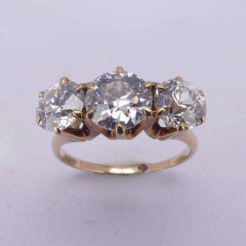 214 - A three stone diamond Ring, the central brilliant cut stone approx. 1.5ct with the outer stones each... 