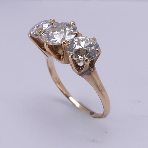 214 - A three stone diamond Ring, the central brilliant cut stone approx. 1.5ct with the outer stones each... 