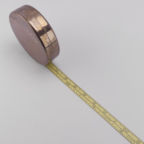 97 - Tiffany & Co.; A circular silver Tape Measure, 2m / 79