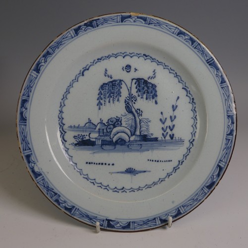 9 - A 19thC English delft Plate, possibly London, decorated in the Chinese style, with central willow ha... 