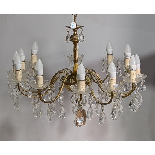 336 - A 20th century gilt metal twelve light Chandelier, decorated with an array of cut and faceted glass ... 