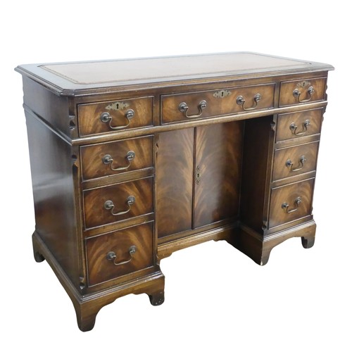 345 - A mahogany kneehole Desk, chamfered top inset with leather writing surface, above frieze drawer and ... 