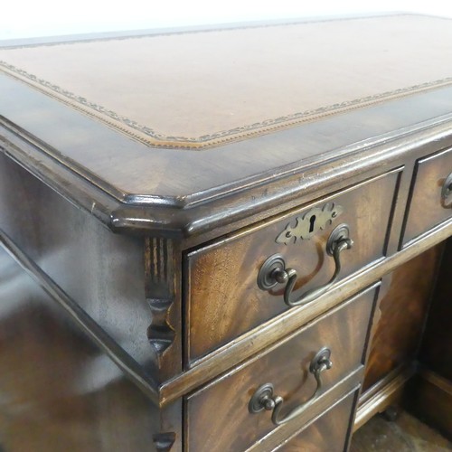 345 - A mahogany kneehole Desk, chamfered top inset with leather writing surface, above frieze drawer and ... 