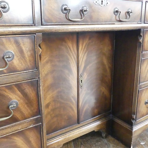 345 - A mahogany kneehole Desk, chamfered top inset with leather writing surface, above frieze drawer and ... 