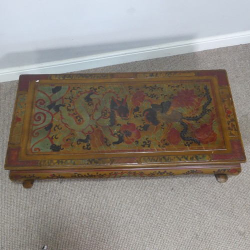 357 - A Chinese style lacquered and painted coffee Table, depicting serpents and foliage, raised on cabrio... 