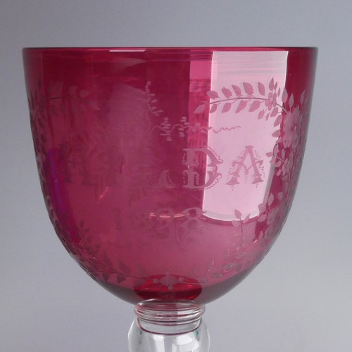 11 - A large Victorian engraved cranberry Glass, reading 'HILDA 1898' within foliate border, raised on ho... 