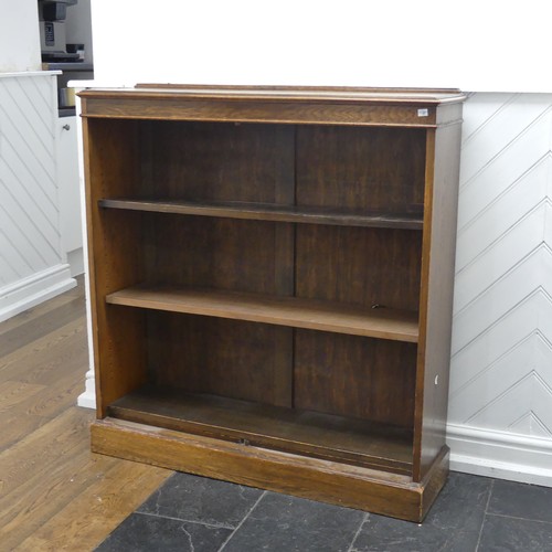 347 - A 20th century oak open bookcase, of three adjustable shelves, raised on plinth base, W 106 cm x H 1... 