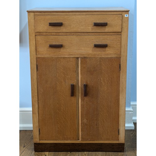 348 - A 1930s oak Tall Boy in the manner of Heals, two drawers over cupboard, all inset with Heals style o... 