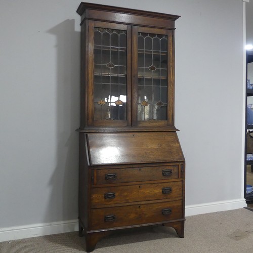 355 - An Arts and Crafts oak bureau Bookcase, cornice over lead framed stained glass, raised on Bureau bas... 