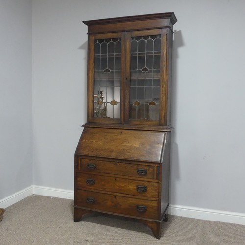 355 - An Arts and Crafts oak bureau Bookcase, cornice over lead framed stained glass, raised on Bureau bas... 