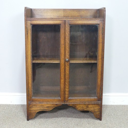 358 - An early 20th century small oak Bookcase, with glazed doors enclosing shelf, W 59.5 cm x H 89 cm x D... 