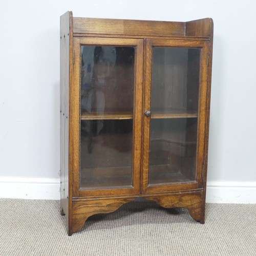 358 - An early 20th century small oak Bookcase, with glazed doors enclosing shelf, W 59.5 cm x H 89 cm x D... 