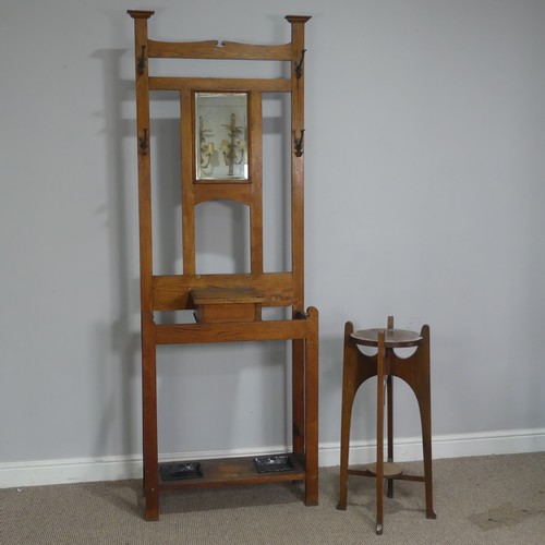 372 - An Arts and Crafts oak Hall Stand, central bevelled Mirror flanked by two coat hooks to either side,... 