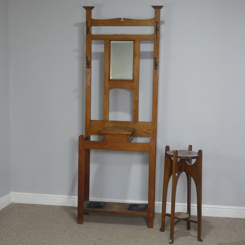 372 - An Arts and Crafts oak Hall Stand, central bevelled Mirror flanked by two coat hooks to either side,... 