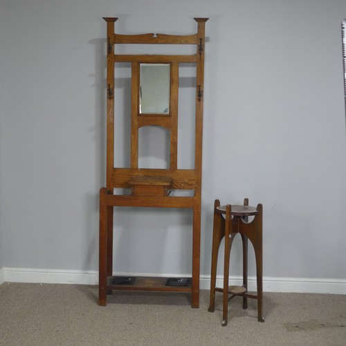 372 - An Arts and Crafts oak Hall Stand, central bevelled Mirror flanked by two coat hooks to either side,... 