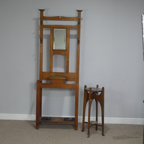 372 - An Arts and Crafts oak Hall Stand, central bevelled Mirror flanked by two coat hooks to either side,... 