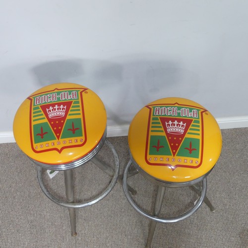 379 - A pair of ''Rock-ola'' Bar Stools, having printed tops on chromed bases, the revolving tops read ''R... 