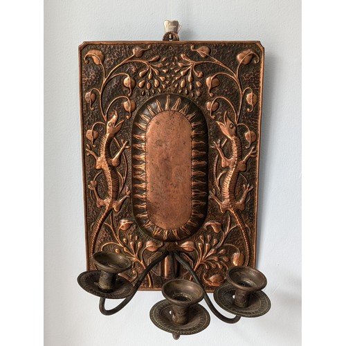 393 - John Pearson (1859-1930) An Arts and Crafts copper wall Sconce, embossed with central raised sun sur... 