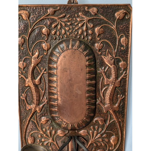 393 - John Pearson (1859-1930) An Arts and Crafts copper wall Sconce, embossed with central raised sun sur... 