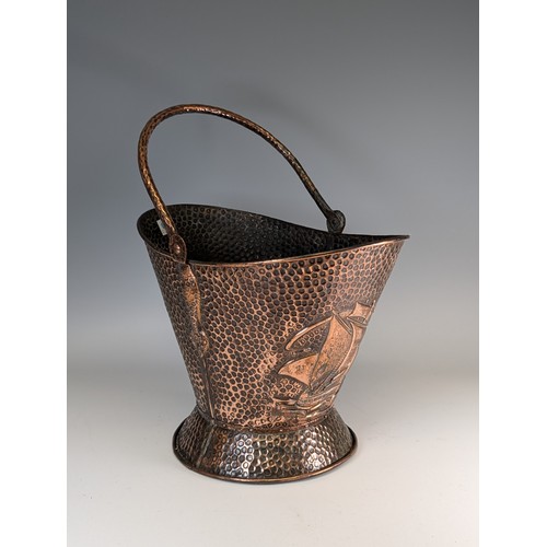 398 - J & F Pool of Hayle an Arts and Crafts hammered copper coal Scuttle, embossed with sailing ships... 