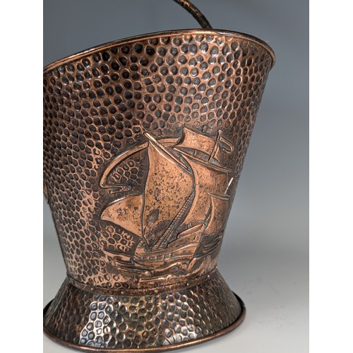 398 - J & F Pool of Hayle an Arts and Crafts hammered copper coal Scuttle, embossed with sailing ships... 