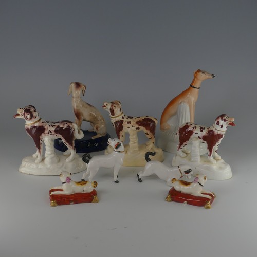 14 - A pair of antique Staffordshire pottery figures of Pugs, seated on red cushions, H 4.2cm, together w... 