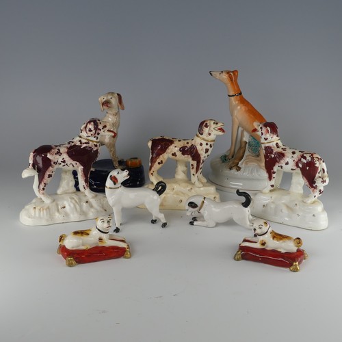 14 - A pair of antique Staffordshire pottery figures of Pugs, seated on red cushions, H 4.2cm, together w... 