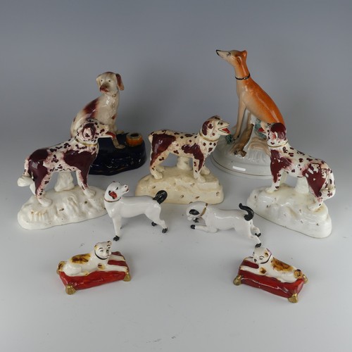 14 - A pair of antique Staffordshire pottery figures of Pugs, seated on red cushions, H 4.2cm, together w... 