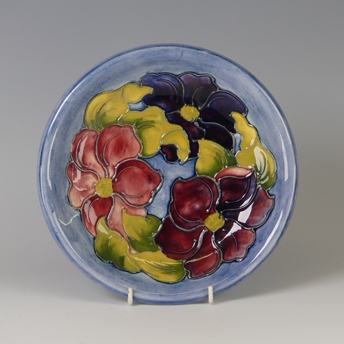 50 - A Walter Moorcroft pottery 'Clematis' pattern Plate, decorated in tubelined design on powder blue gr... 