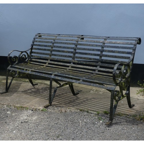 412 - A Victorian strapped iron Garden Bench / Seat, painted black, with scrolled supports and armrests, r... 