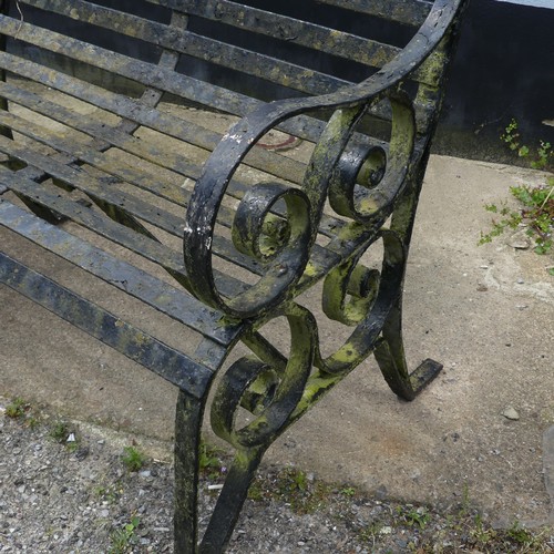 412 - A Victorian strapped iron Garden Bench / Seat, painted black, with scrolled supports and armrests, r... 