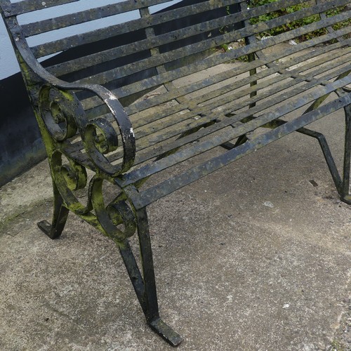 412 - A Victorian strapped iron Garden Bench / Seat, painted black, with scrolled supports and armrests, r... 