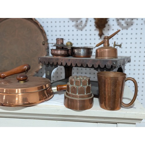 413 - An Army & Navy copper Hot Plate, together with three other copper Hot Plates and associated burn... 