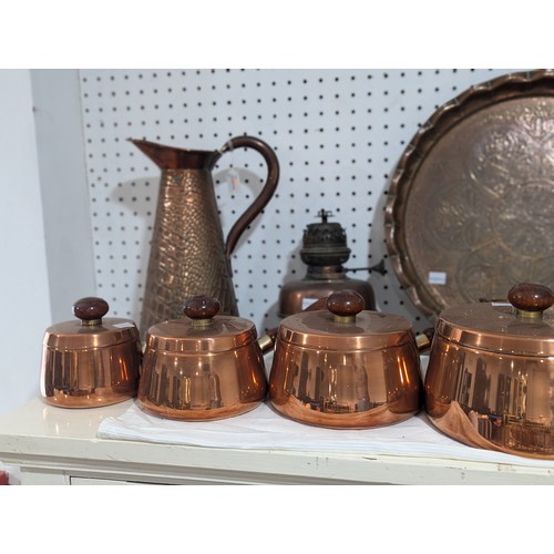 413 - An Army & Navy copper Hot Plate, together with three other copper Hot Plates and associated burn... 