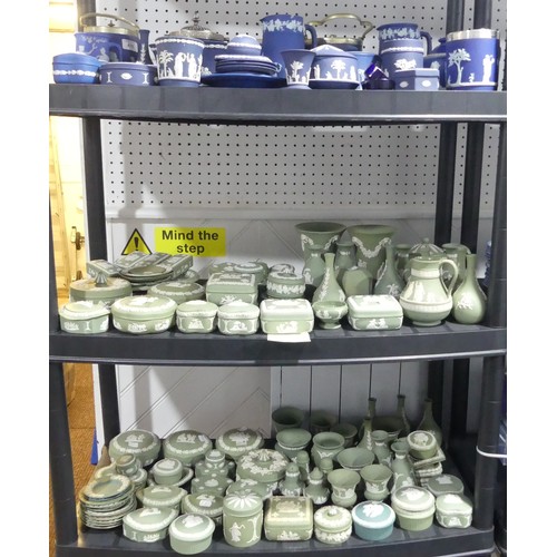 56 - A large quantity of Wedgwood Jasperwares, in green colourway, comprising Bottle Vases, Trumpet Vases... 