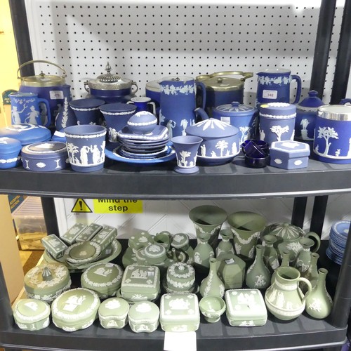 56 - A large quantity of Wedgwood Jasperwares, in green colourway, comprising Bottle Vases, Trumpet Vases... 