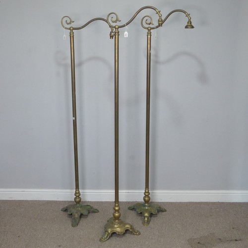 417 - A set of three Victorian brass standard Lamps, having a scrolled single sconce over a central cylind... 