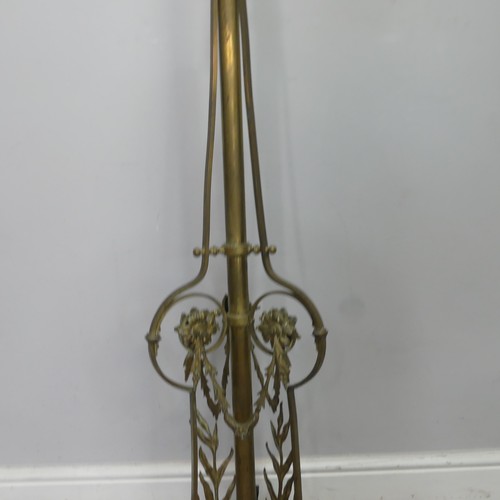 420 - A late 19th century ornate telescopic brass standard Lamp, decorated in relief with scrolls, raised ... 