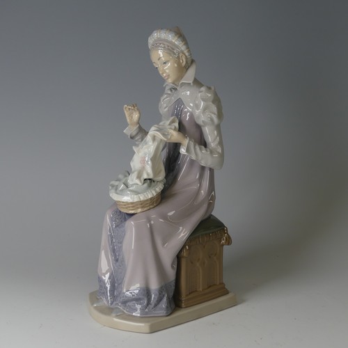 61 - A Lladro figure of a Medieval Lady, modelled seated doing embroidery, 5126, marks to base, H 29cm.... 