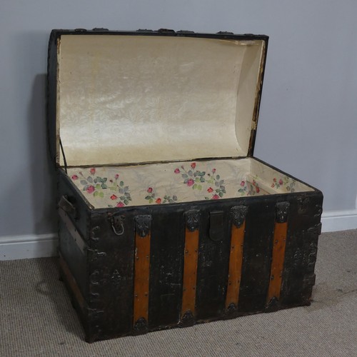 421 - An antique metal and oak bound dome-topped Trunk / Chest, the trunk and hinged lid with oak bound st... 