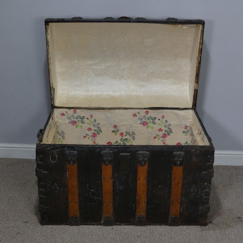 421 - An antique metal and oak bound dome-topped Trunk / Chest, the trunk and hinged lid with oak bound st... 