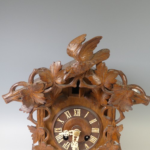 310 - A late 19th Century Black Forest carved softwood mantel cuckoo Clock, by Gordian Hettich Sohn, with ... 